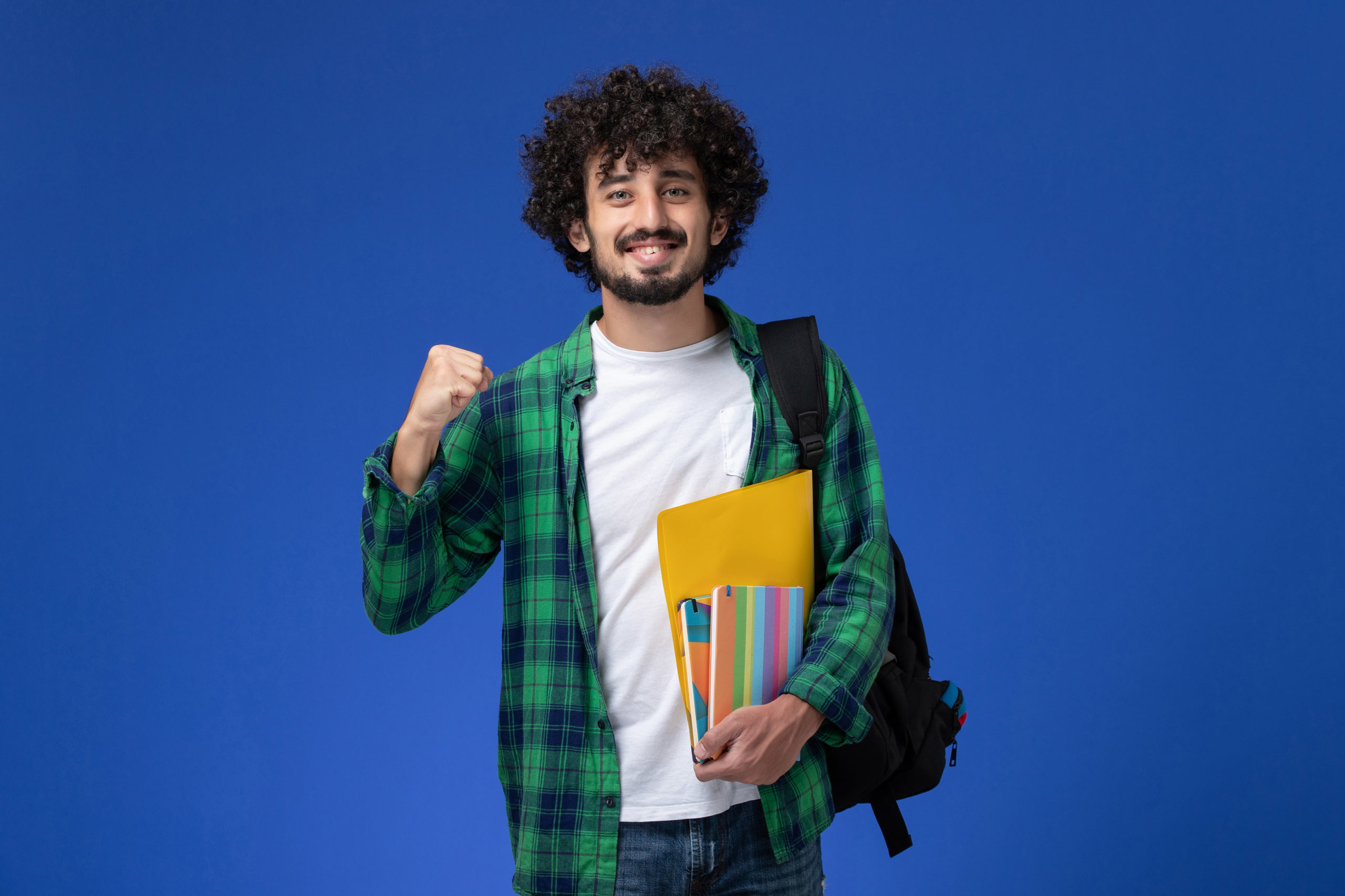 front view male student wearing black backpack holding copybooks files blue wallffff scaled
